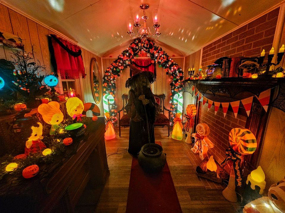 Interior of life-size witch cottage and bubbling cauldron decorated for Halloween